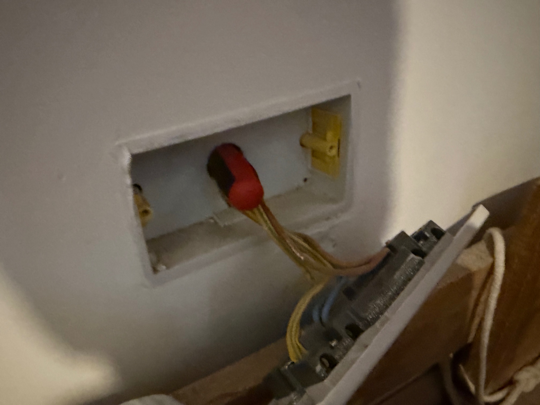 A spike from the original socket to find where to cut the new socket in on the bedroom wall (Precision work!)