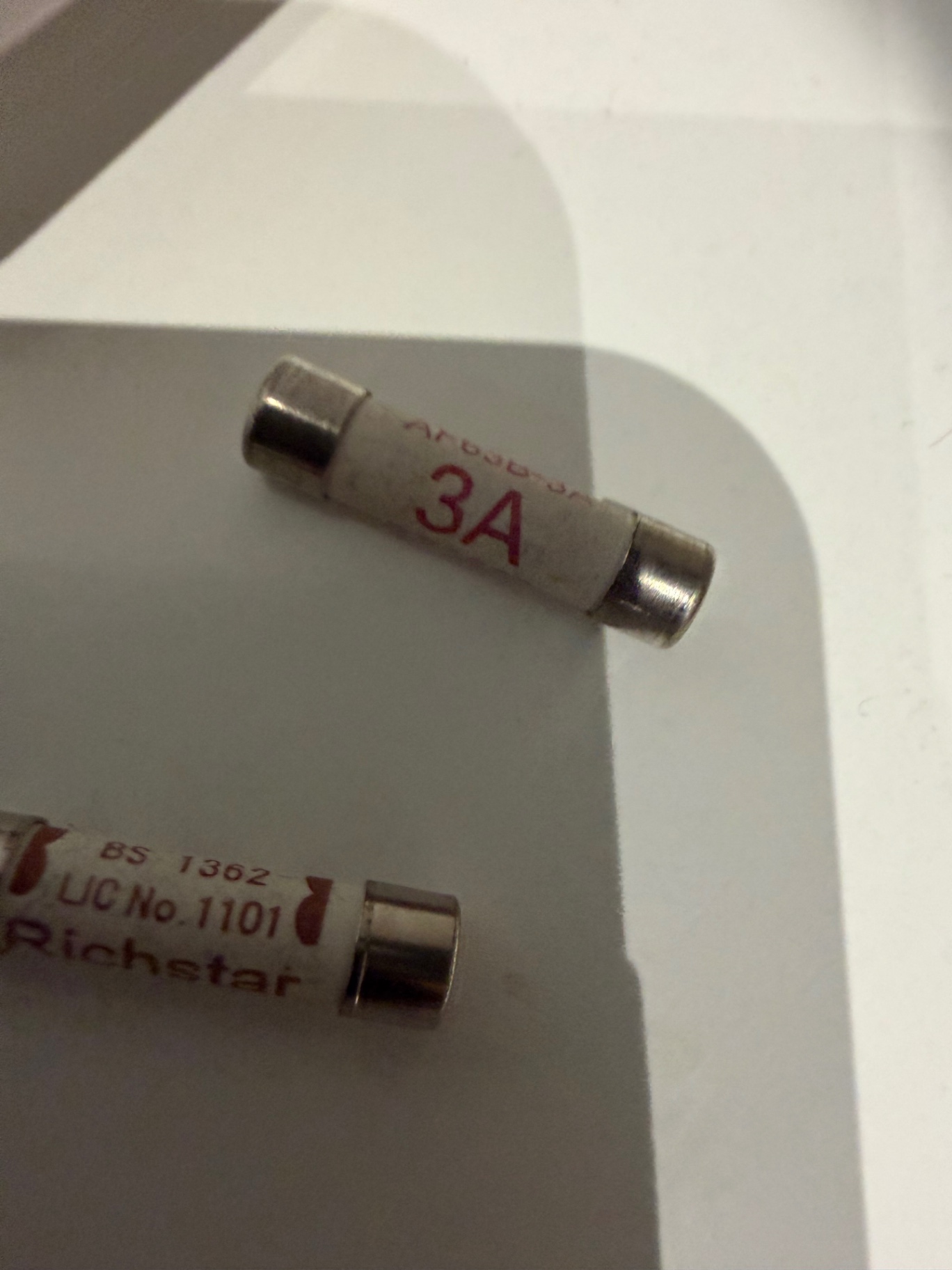 The original BS 1362 3A cartridge fuses recovered from the faulty spur — checked and replaced with new fuses on refit.