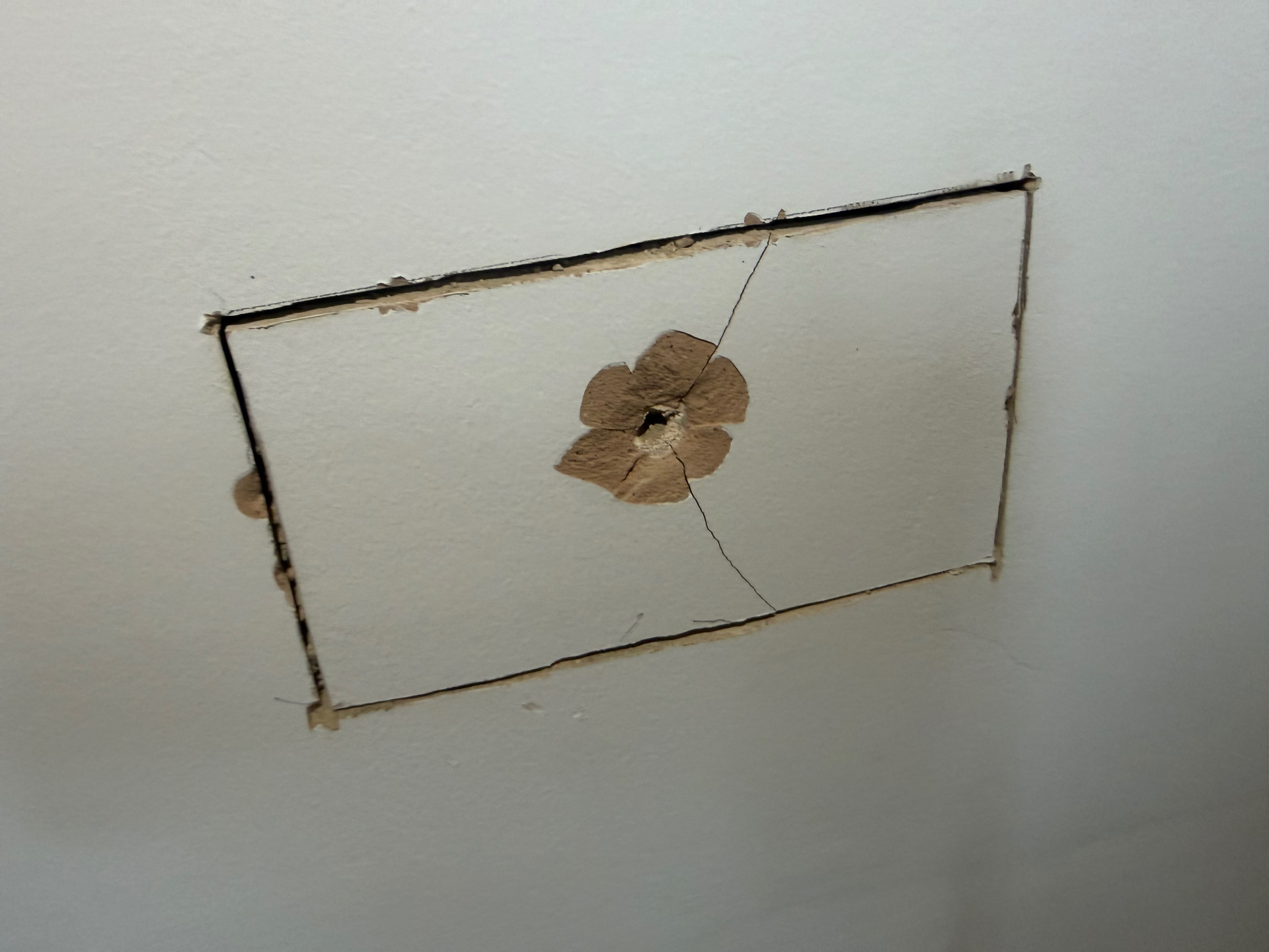 Neat rectangular chase cut into the lath and plaster wall for the new back box
